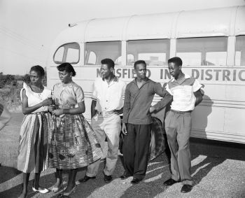 Five black teens in front of a Mansfield school bus
